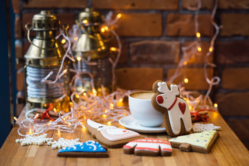 Christmas gingerbread cookie deer and cup of coffee at yellow fe