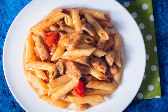 Penne pasta with mushrooms, chicken, tomatoes and cheese parmesa