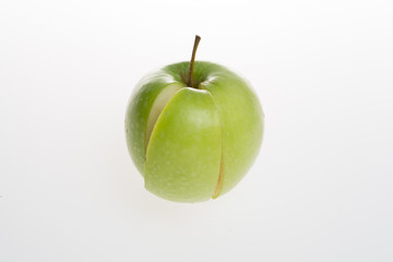 apple with slice, green and white background