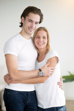 Portrait of couple of young man and woman in love. Two smiling people wearing casual white t-shirt uniform, volunteer around the world program, teambuilding course, volunteer travel organization