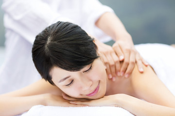 Fototapeta na wymiar young woman in spa salon getting massage