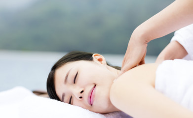 Obraz na płótnie Canvas young woman in spa salon getting massage