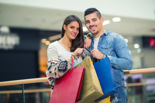 Portrait of happy couple with shopping bags