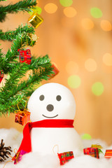 Snowman and gift boxes on bokeh background