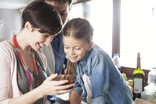 Family looking at smartphone together