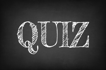 Quiz written with chalk on blackboard education concept