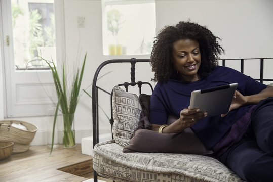 Woman connecting to social media using digital tablet