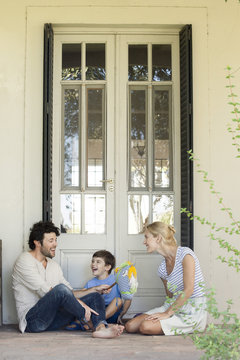 Family with one child having lighthearted time together outdoors