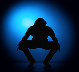 silhouette Rocker man posing on blue background