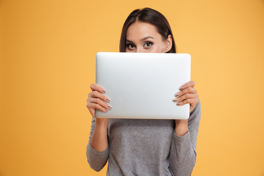 Model Hiding Behind Laptop