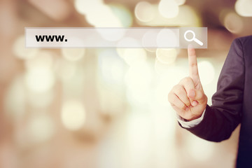 Businessman hand touching search bar with www. 