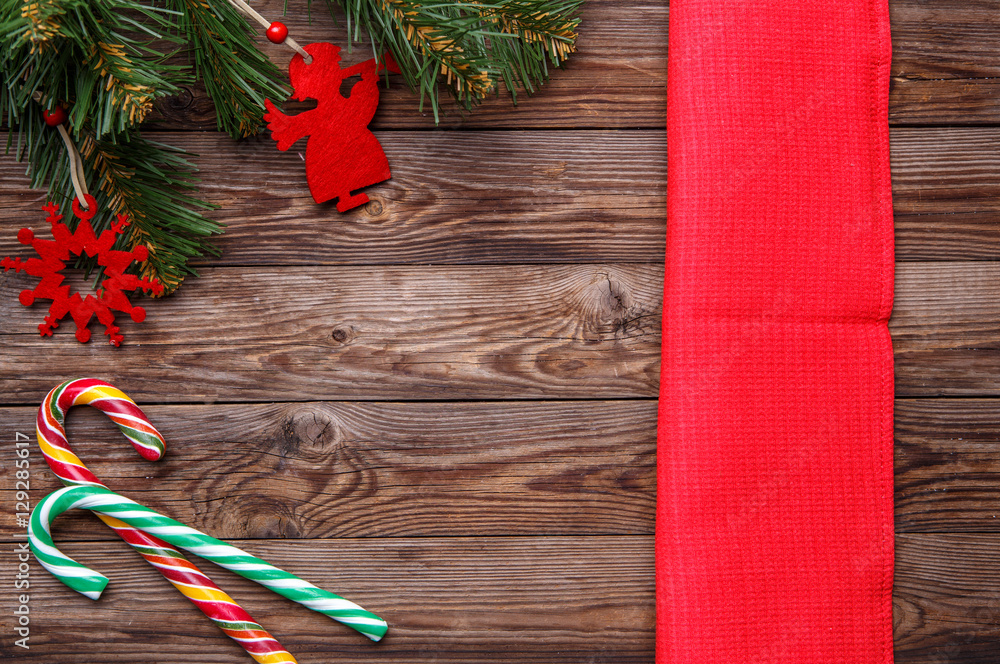 Wall mural christmas table place setting, decorated christmas pine branches with christmas toys, two lollipop c