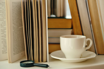 cup of tea on a background of old books