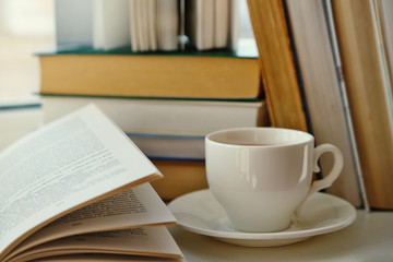 cup of tea on a background of old books
