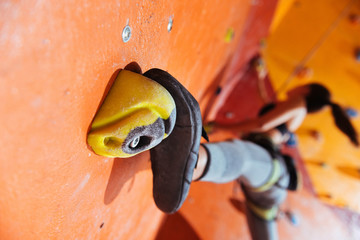 Pretty woman training hard in climbing gym