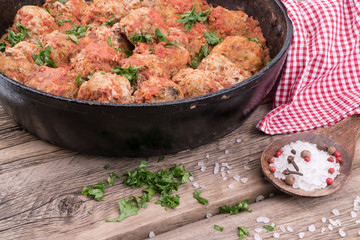 meat balls with herbs in pan on wooden rustic background.