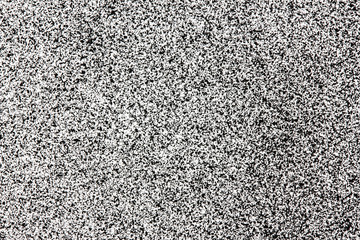 Abstract closeup white spray paint on black paper.