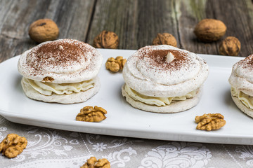 Detail on Walnuts Meringue with cocoa with cracking walnuts