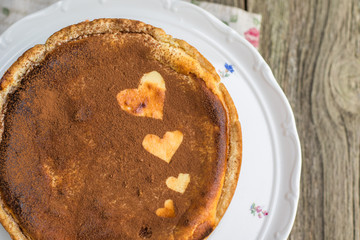 Detailed top View on baked cheesecake sprinkled with cocoa with