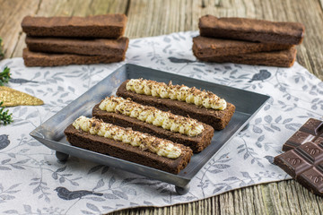 Small cocoa cakes with whipped buttercream on metal plate