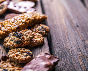 Set of sweets. Chocolate bars and granola on a wooden background with milk chocolates. Food, candy, snack