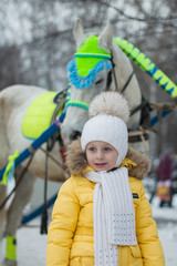a girl with a horse in the winter carnival. Russia.