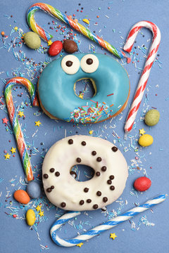 Funny glazed donuts on blue background