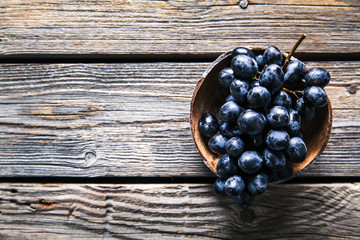 Top view of grapes in basket on wooden table. fruits