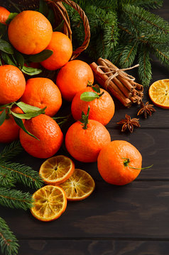 Fresh tangerine clementine with spices on dark wooden background, Christmas concept, selective focus, vertical