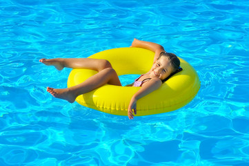 Real toddler girl at swimming pool