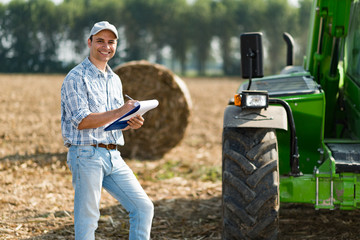 Farmer writing on a document