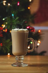 Cup of coffee with marshmallow on wooden table