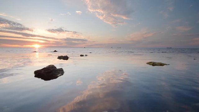 Beautiful seascape on the sunset. Calm mood on the sea. Reflections of sky on the waves.