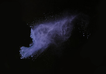 Launched colorful powder on black background