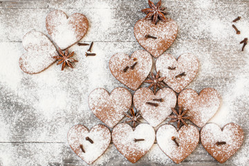 Christmas heart shaped cookies with sugar powder. Stylized like a fir tree. Top view.
