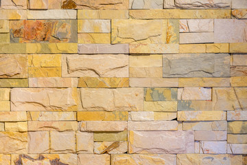 Brick wall in yellow pastel tone