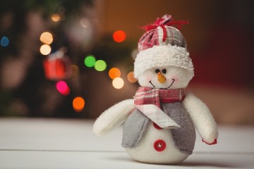 Close-up of snowman on wooden table