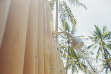 Outdoor shower under palm trees
