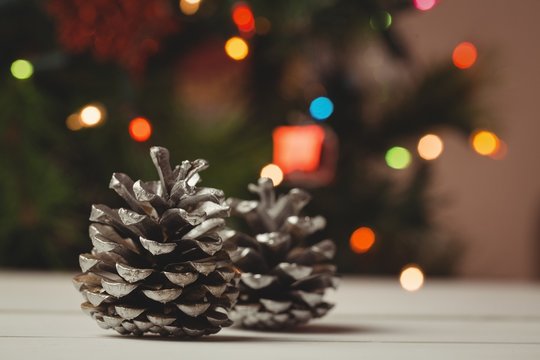 Two pine cones on wooden table