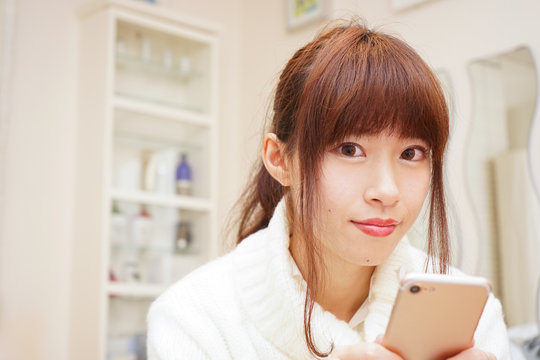 Young woman using a smart phone with smile