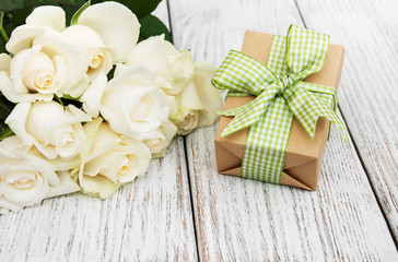 White roses and gift box