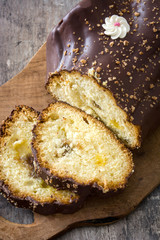 Chocolate yule log christmas cake on wooden background
