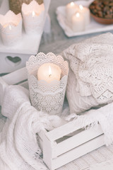 Obraz na płótnie Canvas Cozy wool winter accessory. Warm sweaters candle and wood tray