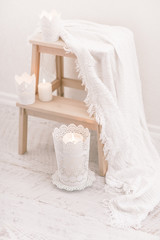Fototapeta na wymiar Cozy wool winter accessory. Warm sweaters candle and wood tray