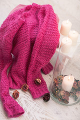 Cozy wool winter accessory. Warm sweaters candle and wood tray