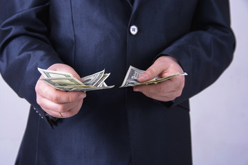 A man in a business suit offers money