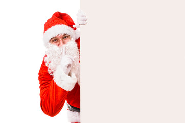 Santa Claus with finger on lips asking for silence, isolated on white background