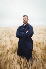 Farmer standing with arms crossed in the field