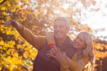 Joyful couple against trees at park