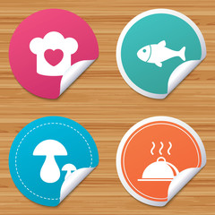 Round stickers or website banners. Chief hat with heart and cooking pan icons. Fish and boletus mushrooms signs. Hot food platter serving symbol. Circle badges with bended corner. Vector
